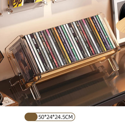 CD holder with transparent stand displaying CDs on a reflective shelf.