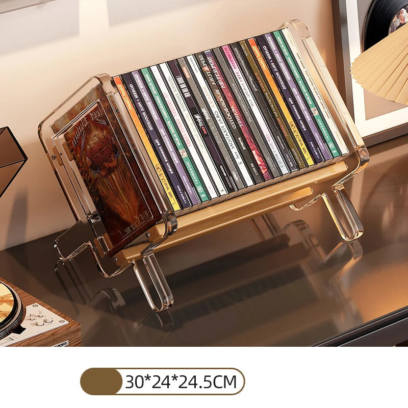 CD holder with transparent cover displaying CDs on a reflective surface.
