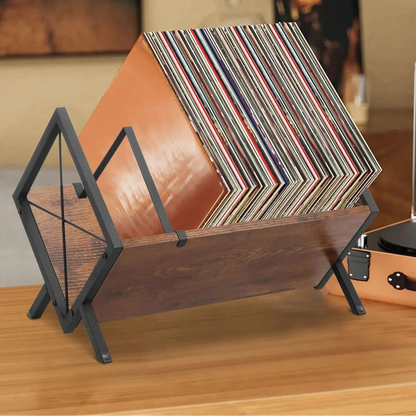 Wooden record holder with vinyl records on a wooden surface