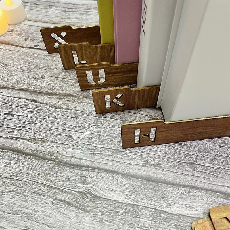 Wooden bookends with letter 'U' on a wooden surface