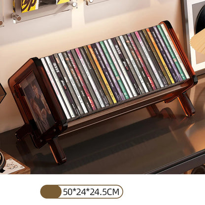 CD holder with an acrylic frame displaying CDs on a shelf.